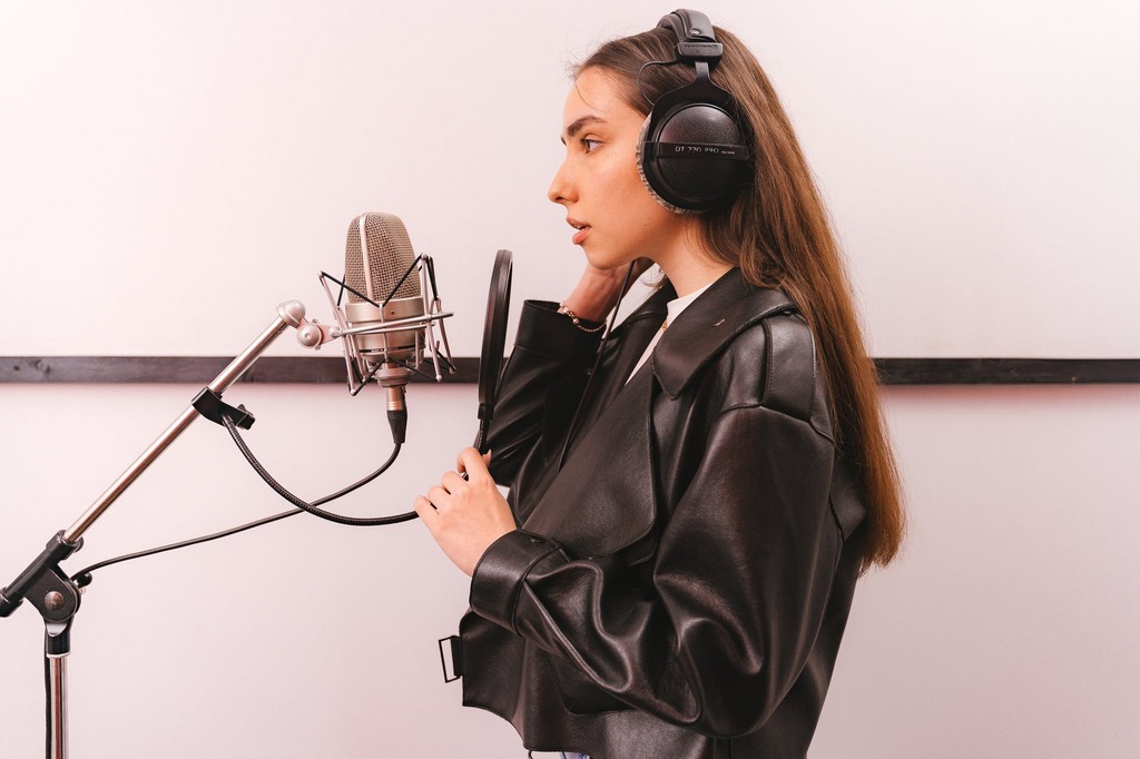 a woman wearing a leather jacket and headphones