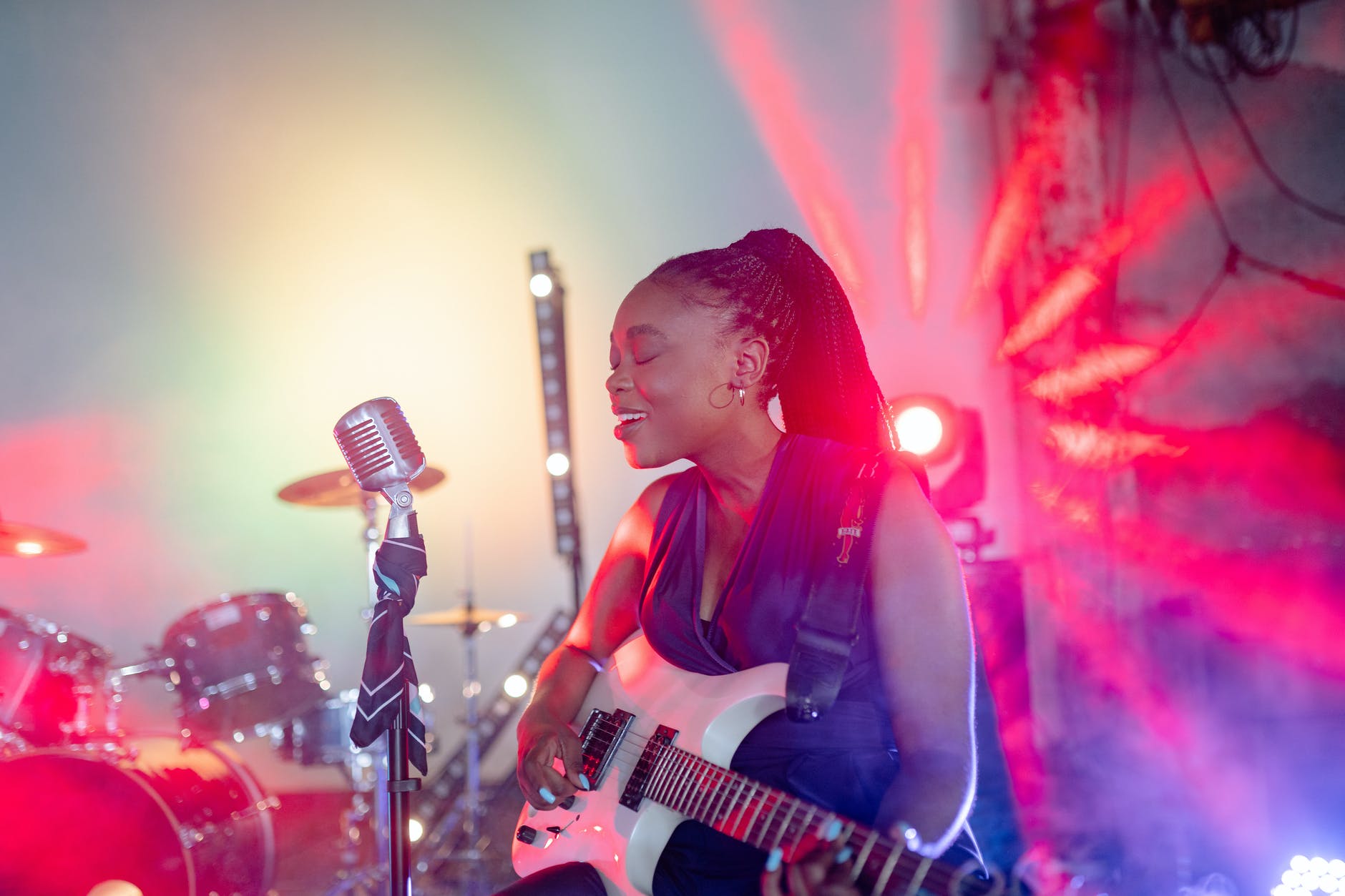 a woman playing the guitar while singing